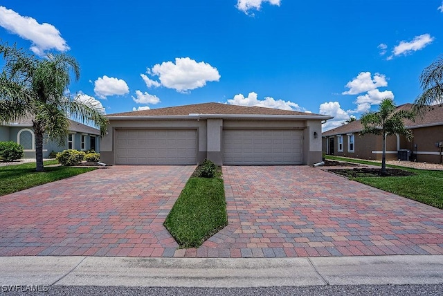 20050 Fiddlewood Ave, North Fort Myers, FL 33917 - view of front of home featuring stucco siding, a garage, and decorative driveway