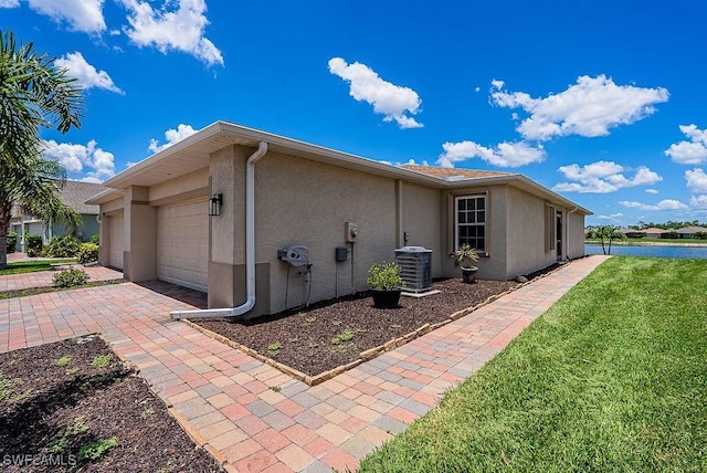 20050 Fiddlewood Ave, North Fort Myers, FL 33917 - view of property exterior with stucco siding, a lawn, an attached garage, and driveway