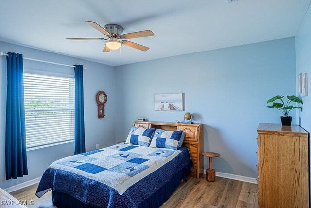20050 Fiddlewood Ave, North Fort Myers, FL 33917 - bedroom featuring wood finished floors and ceiling fan