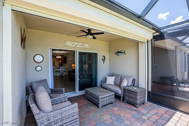 20050 Fiddlewood Ave, North Fort Myers, FL 33917 - view of patio / terrace featuring glass enclosure, a ceiling fan, and outdoor lounge area