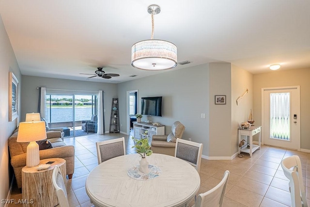 20050 Fiddlewood Ave, North Fort Myers, FL 33917 - dining space with light tile patterned floors and a ceiling fan