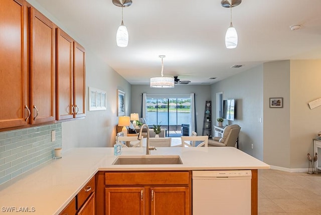 20050 Fiddlewood Ave, North Fort Myers, FL 33917 - kitchen with white dishwasher, a peninsula, open floor plan, and tasteful backsplash