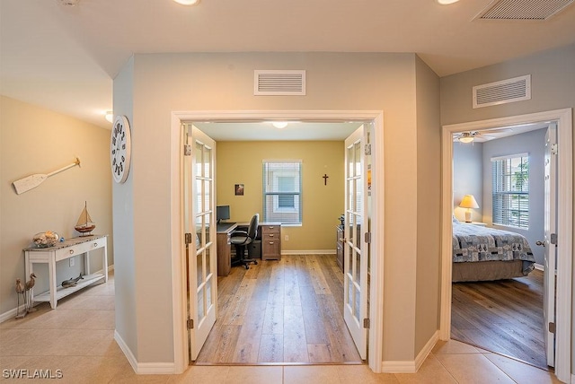 20050 Fiddlewood Ave, North Fort Myers, FL 33917 - corridor featuring an office area, french doors, and wood finished floors