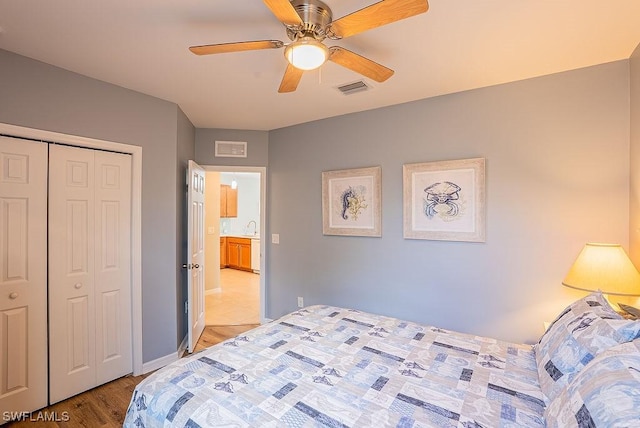 20050 Fiddlewood Ave, North Fort Myers, FL 33917 - bedroom with light wood-style floors, ceiling fan, and a closet