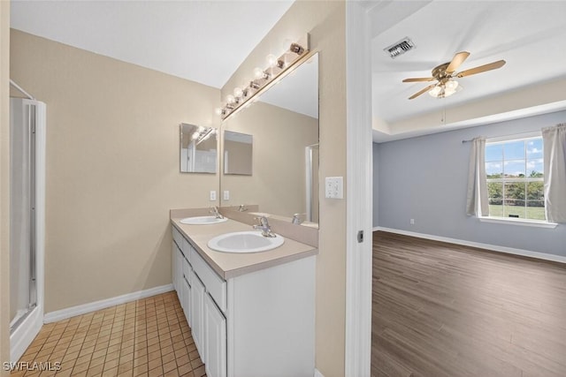 509 Scott Ave, Lehigh Acres, FL 33972 - bathroom with ceiling fan, double vanity, a shower with door, and wood finished floors