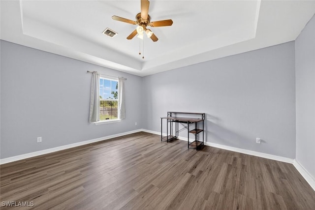 509 Scott Ave, Lehigh Acres, FL 33972 - spare room with a tray ceiling, wood finished floors, and ceiling fan