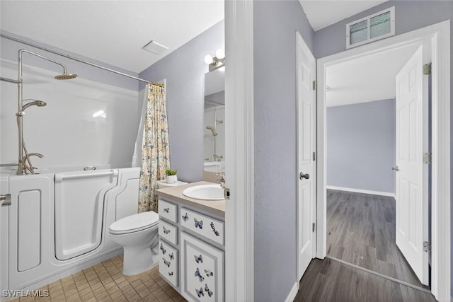 509 Scott Ave, Lehigh Acres, FL 33972 - full bathroom featuring vanity, shower / bath combo with shower curtain, and wood finished floors