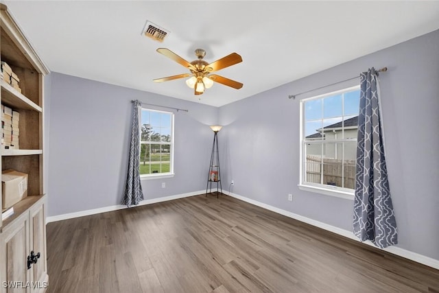 509 Scott Ave, Lehigh Acres, FL 33972 - empty room featuring wood finished floors and a ceiling fan