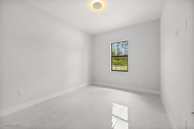 4211 12th Ave NE, Naples, FL 34120 - unfurnished room featuring finished concrete flooring and baseboards