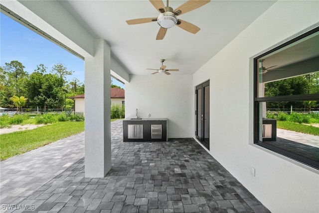4211 12th Ave NE, Naples, FL 34120 - view of patio / terrace with ceiling fan and an outdoor kitchen