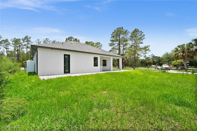 4211 12th Ave NE, Naples, FL 34120 - back of house with stucco siding and a patio