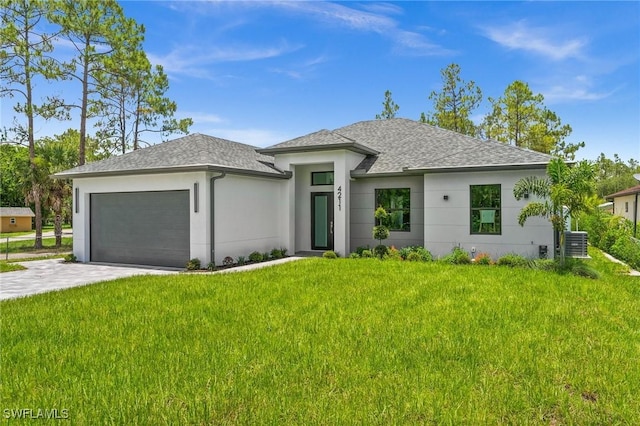 4211 12th Ave NE, Naples, FL 34120 - prairie-style house with an attached garage, a front yard, driveway, a shingled roof, and stucco siding
