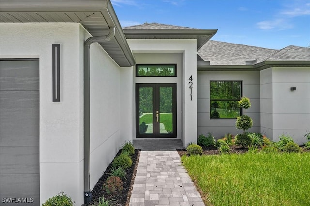 4211 12th Ave NE, Naples, FL 34120 - doorway to property featuring french doors, a shingled roof, and stucco siding