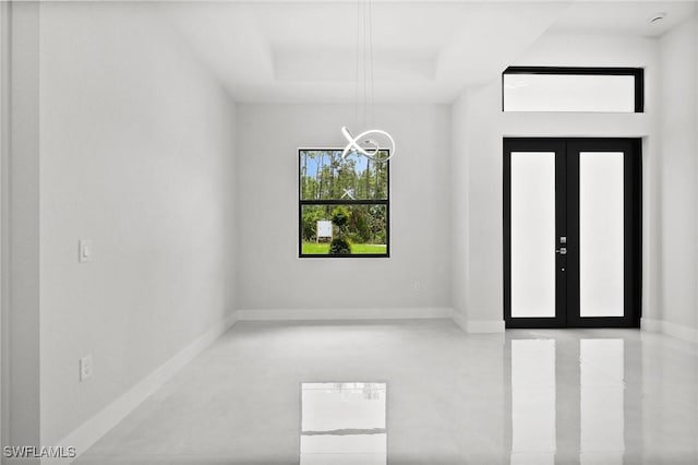 4211 12th Ave NE, Naples, FL 34120 - empty room featuring a chandelier and french doors
