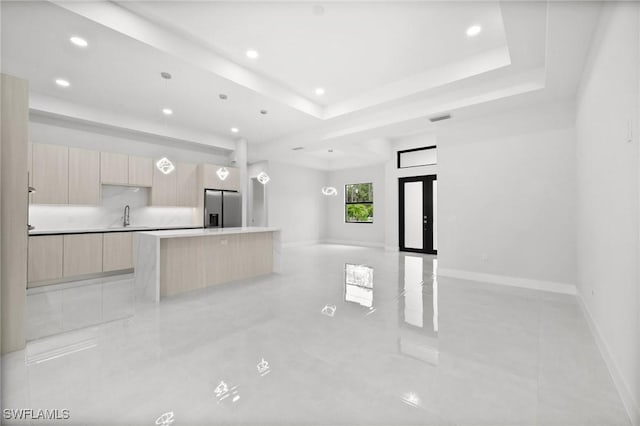 4211 12th Ave NE, Naples, FL 34120 - kitchen with stainless steel refrigerator with ice dispenser, modern cabinets, light brown cabinets, open floor plan, and recessed lighting