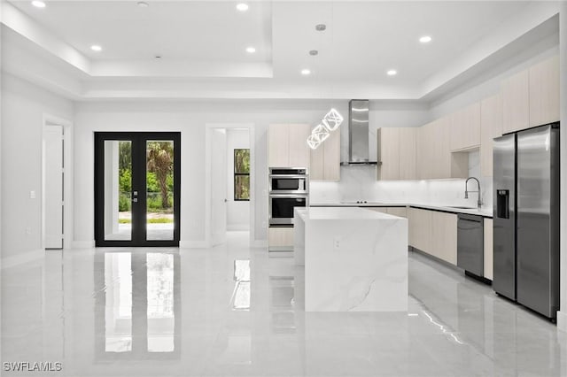 4211 12th Ave NE, Naples, FL 34120 - kitchen with stainless steel appliances, modern cabinets, wall chimney range hood, a raised ceiling, and recessed lighting