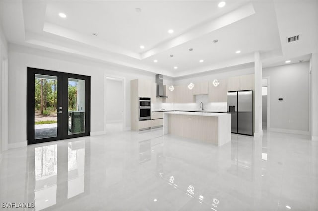 4211 12th Ave NE, Naples, FL 34120 - kitchen with appliances with stainless steel finishes, modern cabinets, wall chimney range hood, a raised ceiling, and recessed lighting