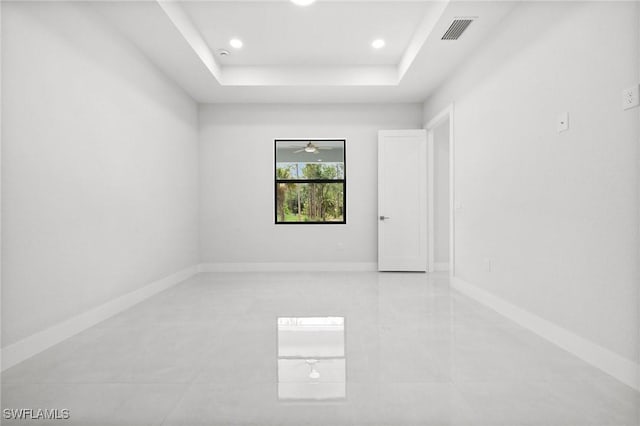 4211 12th Ave NE, Naples, FL 34120 - spare room with a tray ceiling, recessed lighting, light tile patterned floors, and a ceiling fan