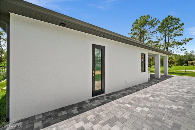 4211 12th Ave NE, Naples, FL 34120 - view of property exterior featuring a patio and stucco siding