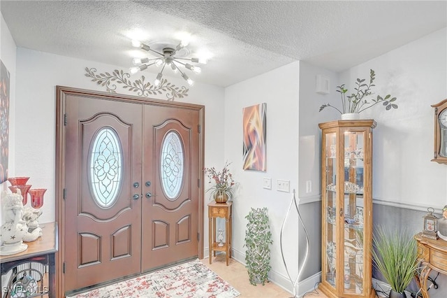 30 Bunker Ln, Rotonda West, FL 33947 - entryway featuring a textured ceiling, a chandelier, and french doors