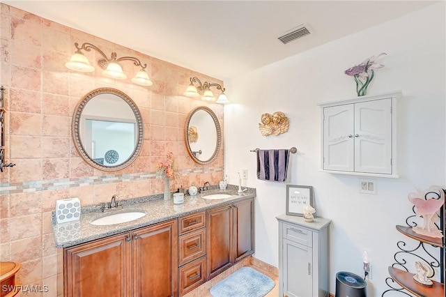 30 Bunker Ln, Rotonda West, FL 33947 - bathroom with double vanity and decorative backsplash