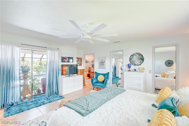 30 Bunker Ln, Rotonda West, FL 33947 - tiled bedroom featuring ceiling fan, ensuite bathroom, and access to outside