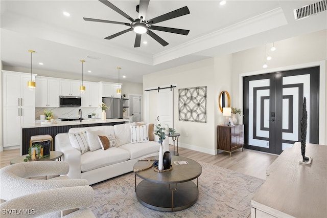 3008 20th St SW, Lehigh Acres, FL 33976 - living area featuring recessed lighting, light wood-type flooring, ornamental molding, a raised ceiling, and a ceiling fan