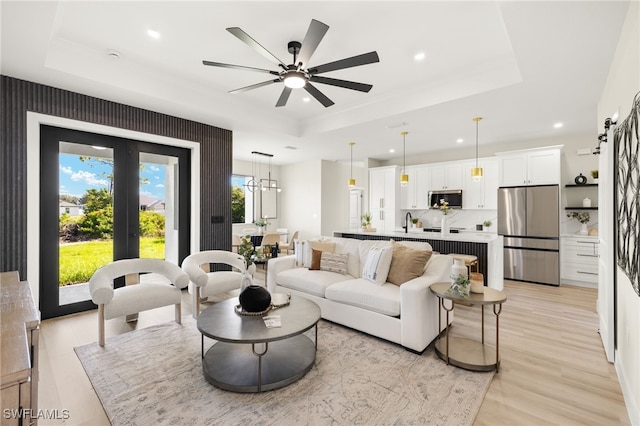 3008 20th St SW, Lehigh Acres, FL 33976 - living area featuring a raised ceiling, recessed lighting, light wood-style flooring, and a ceiling fan