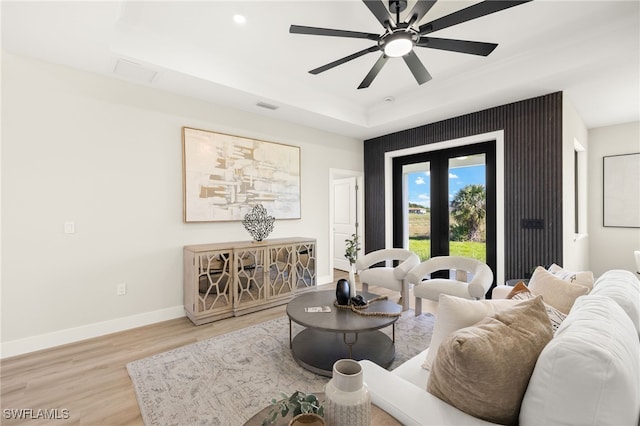 3008 20th St SW, Lehigh Acres, FL 33976 - living room with light wood-style flooring, a ceiling fan, a tray ceiling, and recessed lighting