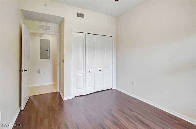 20010 Barletta Ln Unit 612, Estero, FL 33928 - unfurnished bedroom featuring electric panel, dark wood finished floors, and a closet