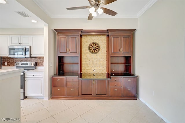 20010 Barletta Ln Unit 612, Estero, FL 33928 - kitchen featuring appliances with stainless steel finishes, ceiling fan, decorative backsplash, crown molding, and light tile patterned floors