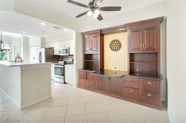 20010 Barletta Ln Unit 612, Estero, FL 33928 - kitchen featuring appliances with stainless steel finishes, a ceiling fan, open shelves, backsplash, and light tile patterned floors