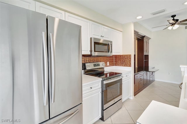20010 Barletta Ln Unit 612, Estero, FL 33928 - kitchen featuring stainless steel appliances, ceiling fan, backsplash, white cabinetry, and light tile patterned floors