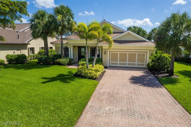 13461 Sabal Pointe Dr, Fort Myers, FL 33905 - single story home featuring decorative driveway, an attached garage, a front lawn, and stucco siding