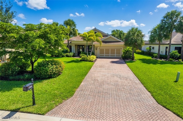 13461 Sabal Pointe Dr, Fort Myers, FL 33905 - ranch-style house featuring decorative driveway, a garage, and a front yard