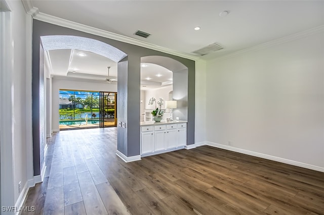 13461 Sabal Pointe Dr, Fort Myers, FL 33905 - spare room featuring arched walkways, crown molding, a ceiling fan, dark wood-style flooring, and recessed lighting
