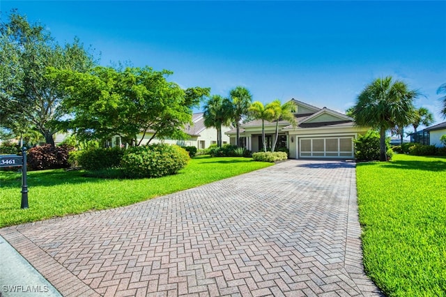 13461 Sabal Pointe Dr, Fort Myers, FL 33905 - view of property hidden behind natural elements with an attached garage, a front lawn, and decorative driveway