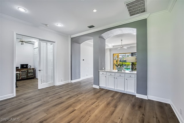 13461 Sabal Pointe Dr, Fort Myers, FL 33905 - unfurnished living room with a ceiling fan, arched walkways, wood finished floors, crown molding, and recessed lighting