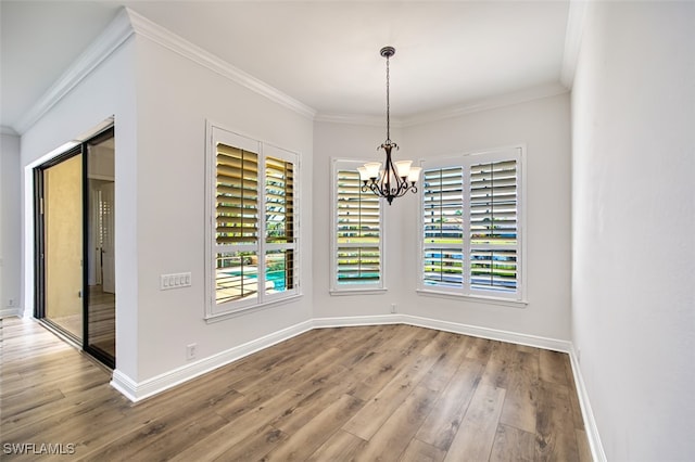 13461 Sabal Pointe Dr, Fort Myers, FL 33905 - unfurnished dining area featuring a chandelier, wood finished floors, and crown molding