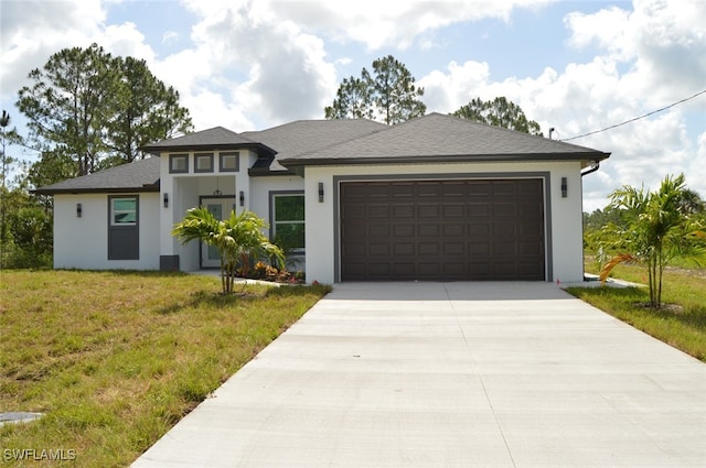 1402 Henry Ave, Lehigh Acres, FL 33972 - prairie-style home with driveway, an attached garage, stucco siding, and a front lawn
