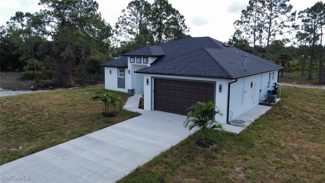 1402 Henry Ave, Lehigh Acres, FL 33972 - view of front facade featuring stucco siding, an attached garage, a shingled roof, concrete driveway, and a front yard