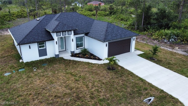 1402 Henry Ave, Lehigh Acres, FL 33972 - view of front facade with an attached garage, stucco siding, driveway, and a front lawn