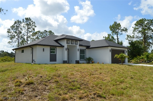1402 Henry Ave, Lehigh Acres, FL 33972 - prairie-style house featuring an attached garage, a front lawn, and stucco siding