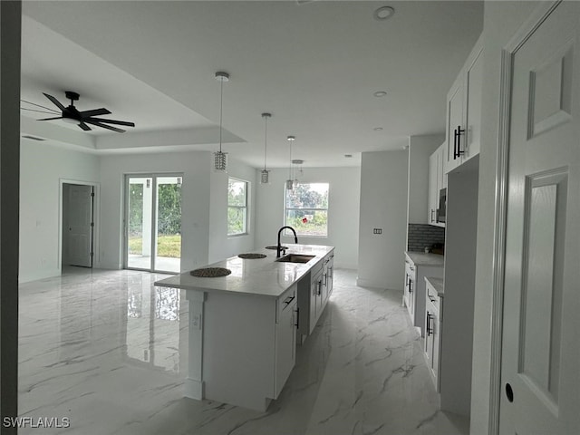 1402 Henry Ave, Lehigh Acres, FL 33972 - kitchen with plenty of natural light, white cabinets, backsplash, a large island with sink, and recessed lighting