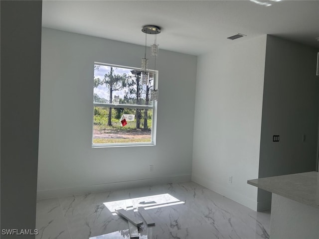 1402 Henry Ave, Lehigh Acres, FL 33972 - unfurnished dining area featuring marble finish flooring and baseboards