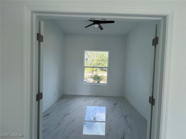 1402 Henry Ave, Lehigh Acres, FL 33972 - unfurnished room with marble finish flooring and ceiling fan