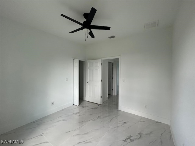 1402 Henry Ave, Lehigh Acres, FL 33972 - empty room featuring a ceiling fan and light marble finish flooring