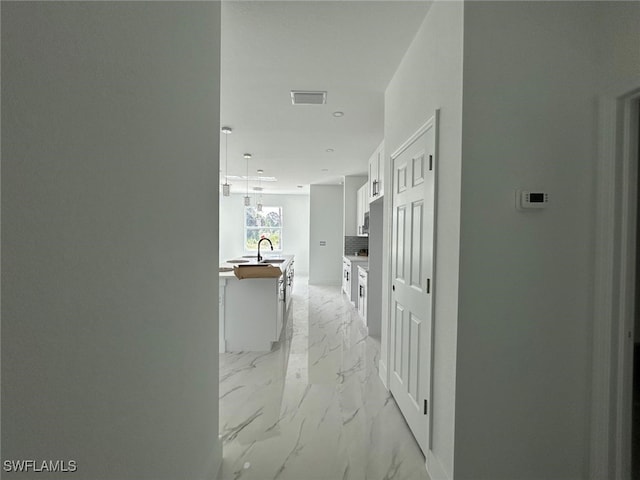 1402 Henry Ave, Lehigh Acres, FL 33972 - hallway featuring light marble finish floors and recessed lighting