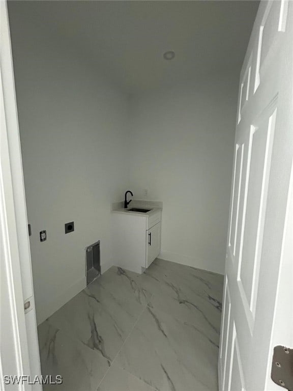 1402 Henry Ave, Lehigh Acres, FL 33972 - laundry room featuring electric dryer hookup and light marble finish flooring