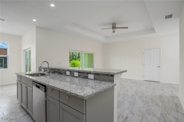 311 Rand Ave, Lehigh Acres, FL 33974 - kitchen featuring dishwasher, gray cabinetry, a center island with sink, a ceiling fan, and light stone counters